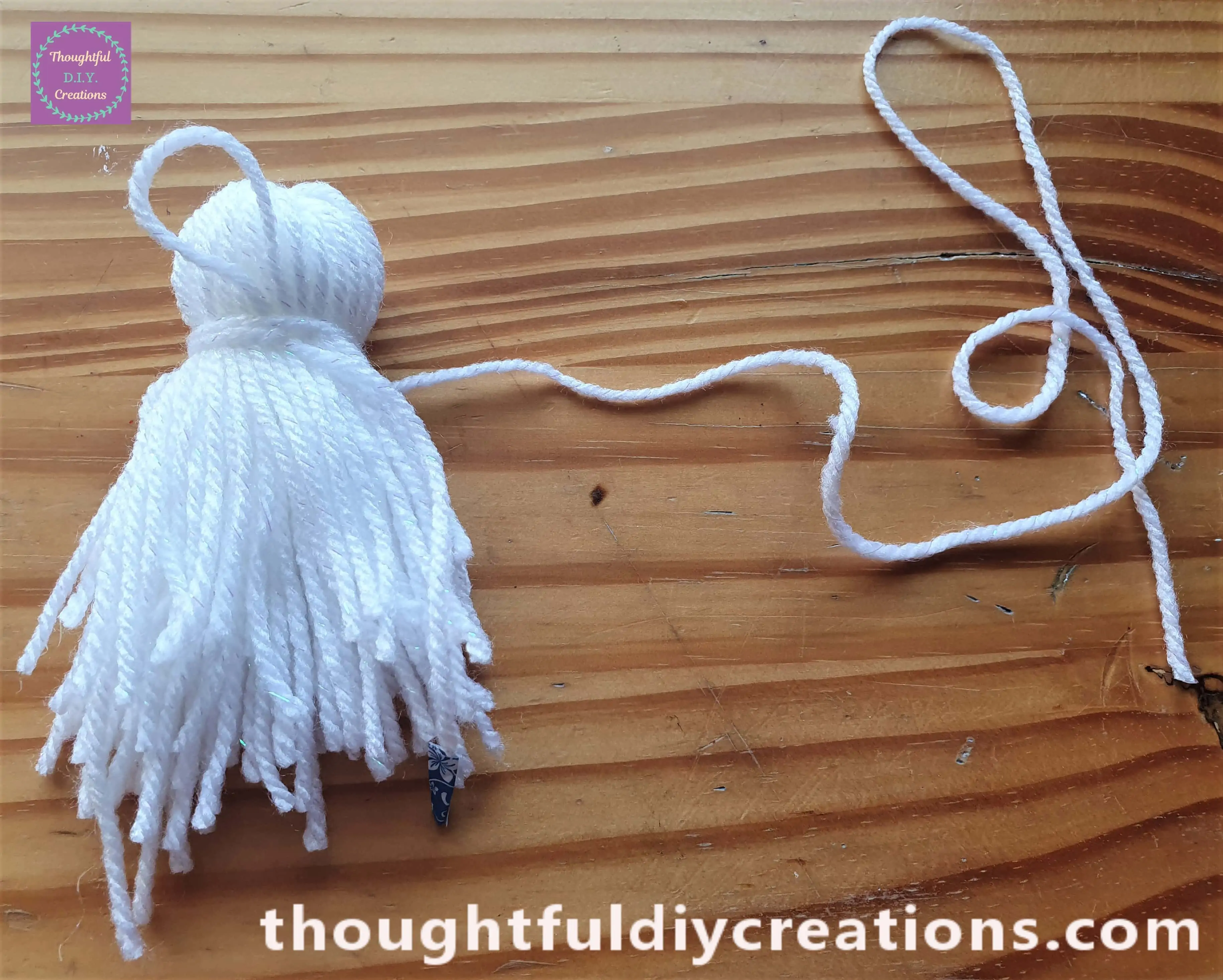 I began wrapping the string of wool around the bundle about an inch down from the top and leaving the loop in tact.