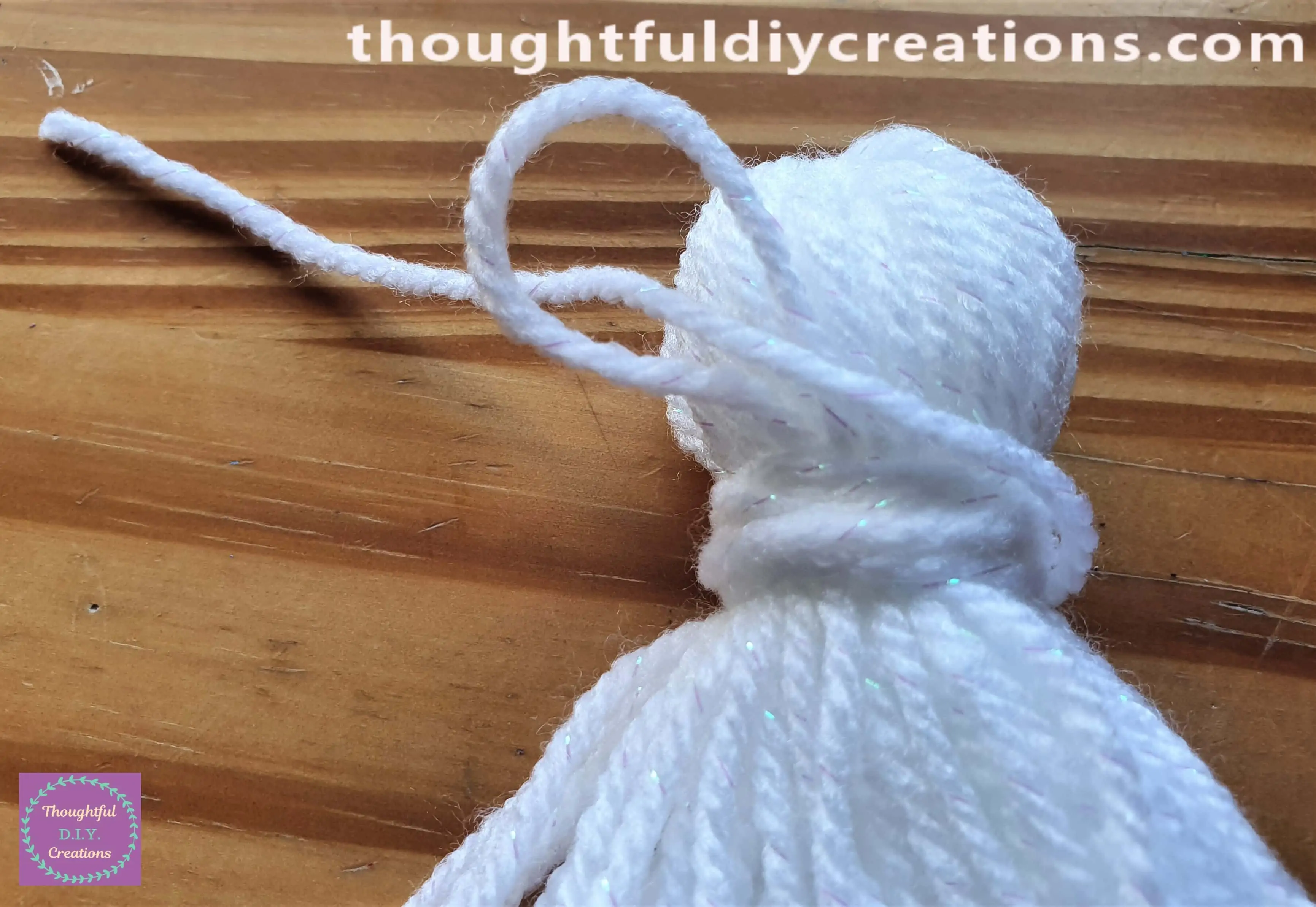 I put the end of wool that I just Cut through the Loop.