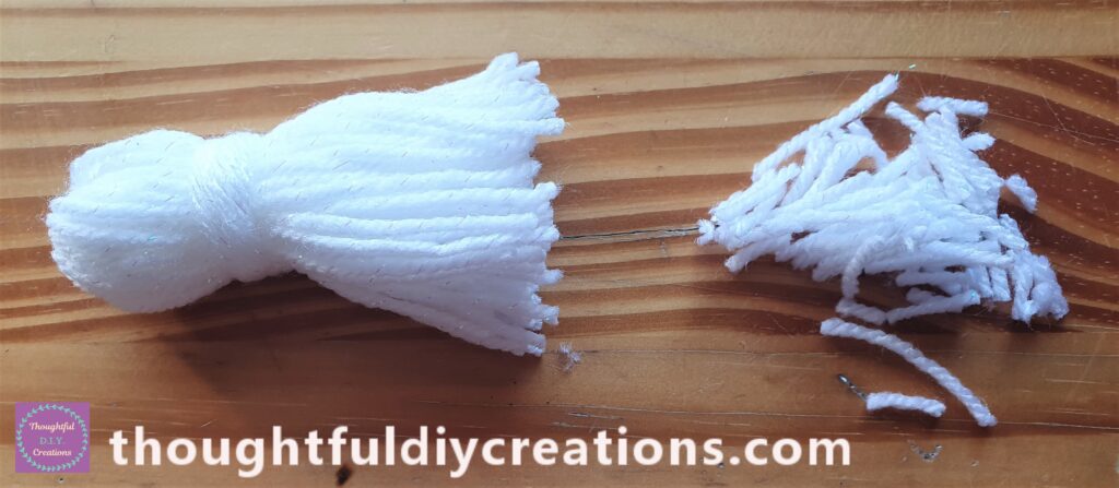 I then flattened the bottom part of the tassel with my left hand and Cut it across with my Scissors using my right hand.