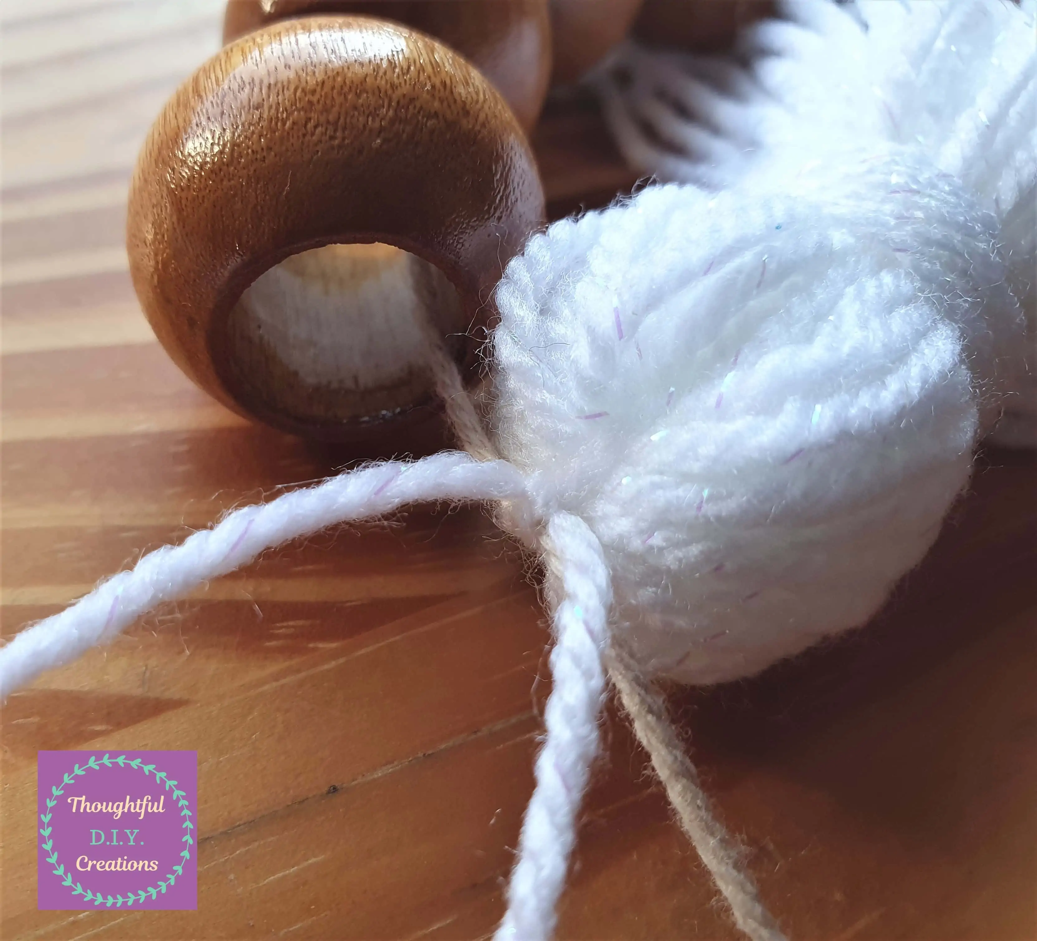 I tied the 2 white strings tightly into a double-knot over the cream string.