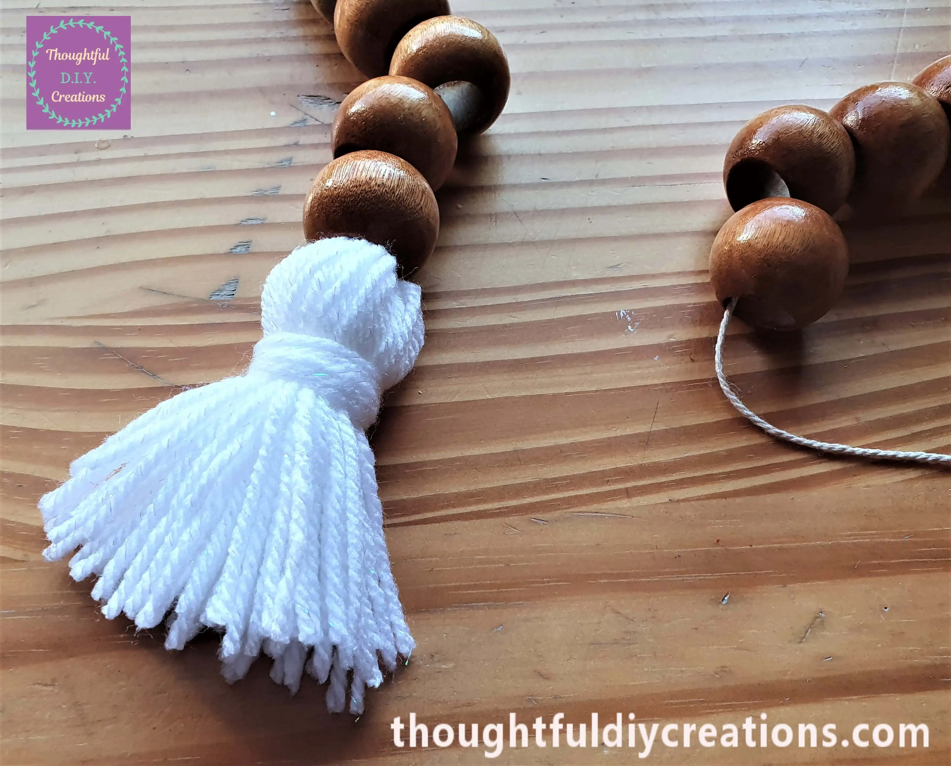 A Closer look at the tassel added to the wooden bead garland.