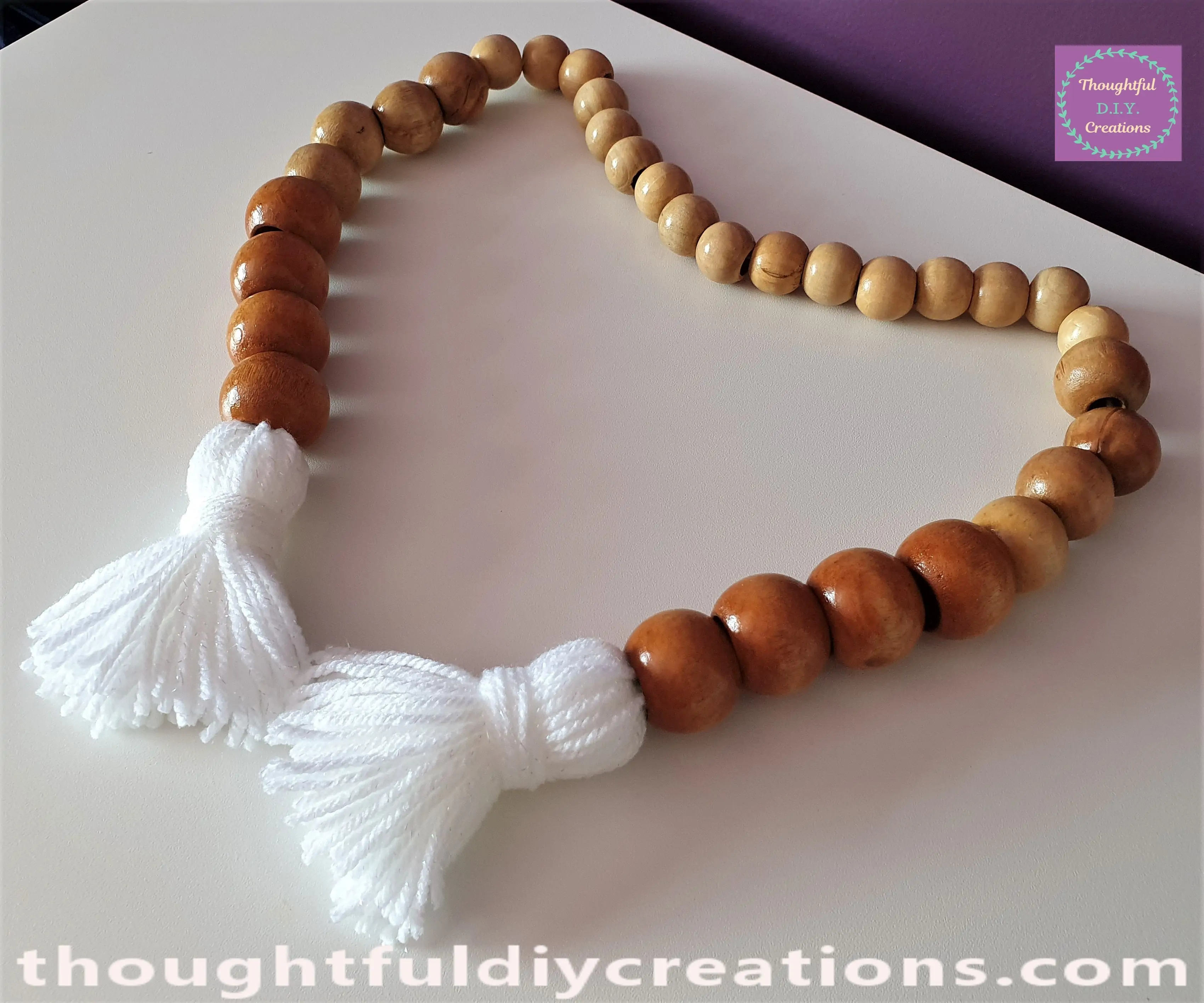 This Completed my Wooden Bead Garland with White Wool Tassels.
