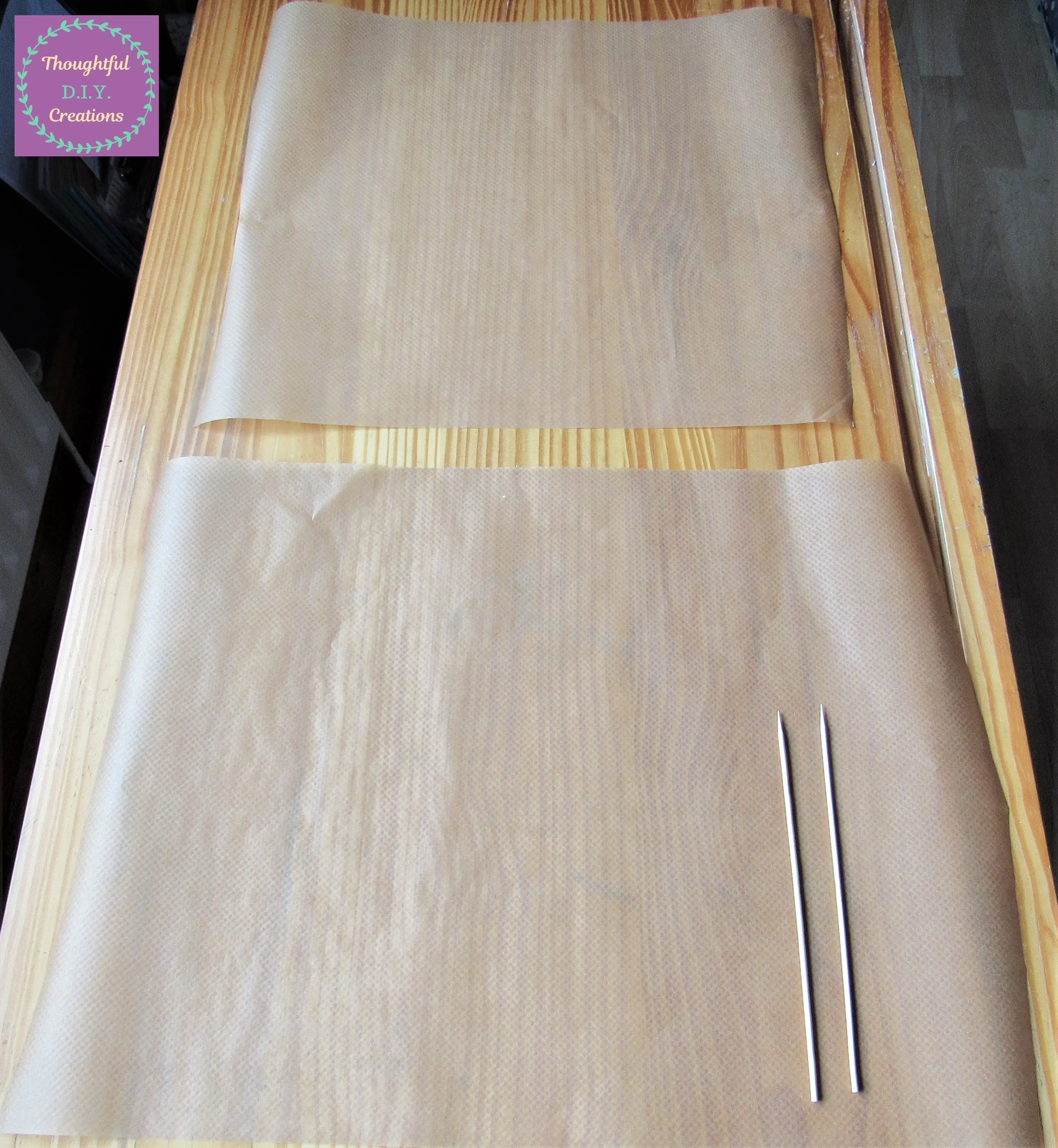 I put 2 Sheets of Baking Paper and 2 Wooden Skewers on the Table.