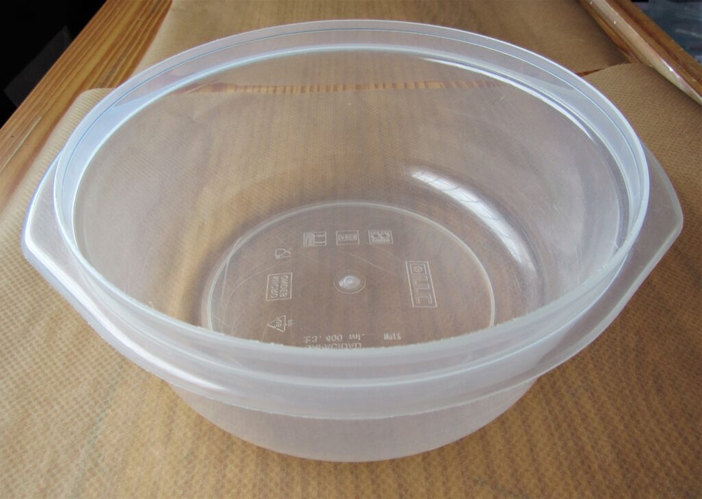 I got a large Plastic Bowl and put it on the first Sheet of Baking Paper.