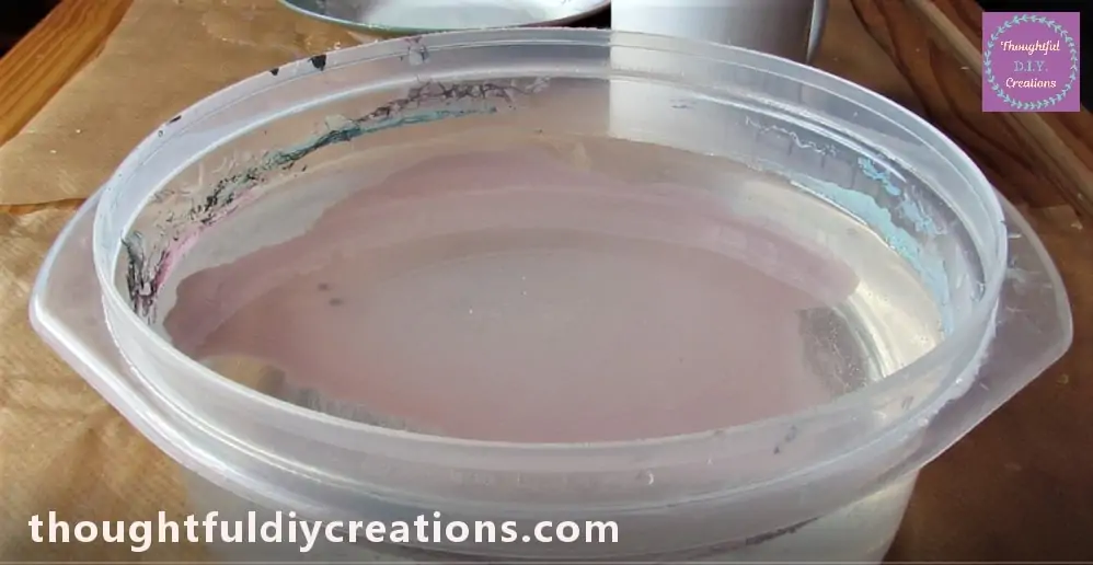 The Colour spreads out, a Paint Film forms on Top of the Water.