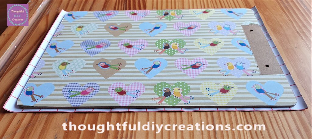 I Cut the Glitter Paper leaving a small border to cover all the Sides of the Clipboard.