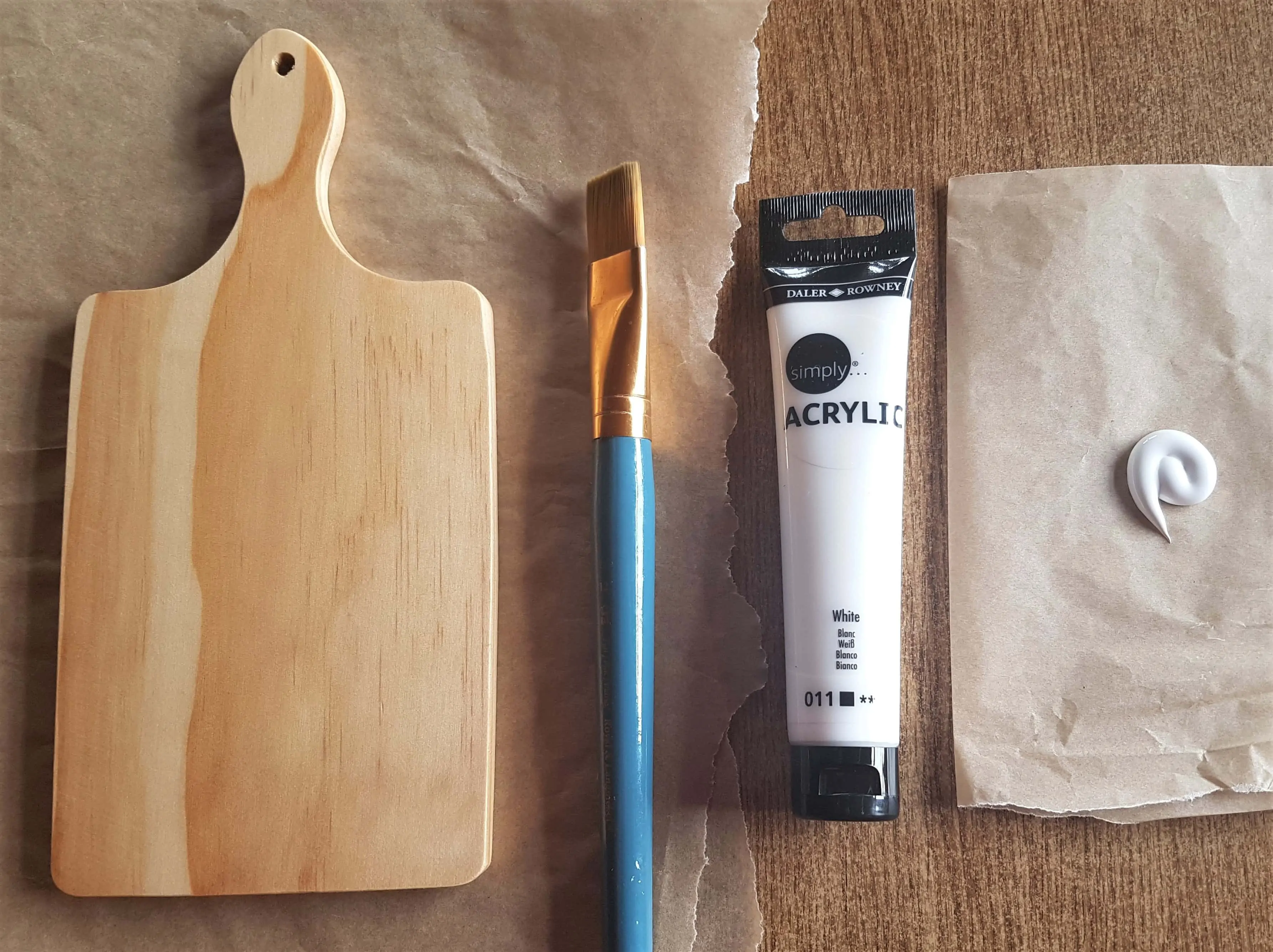 I got my Flat Paintbrush, White Acrylic Paint and poured some Paint onto the Baking Paper.