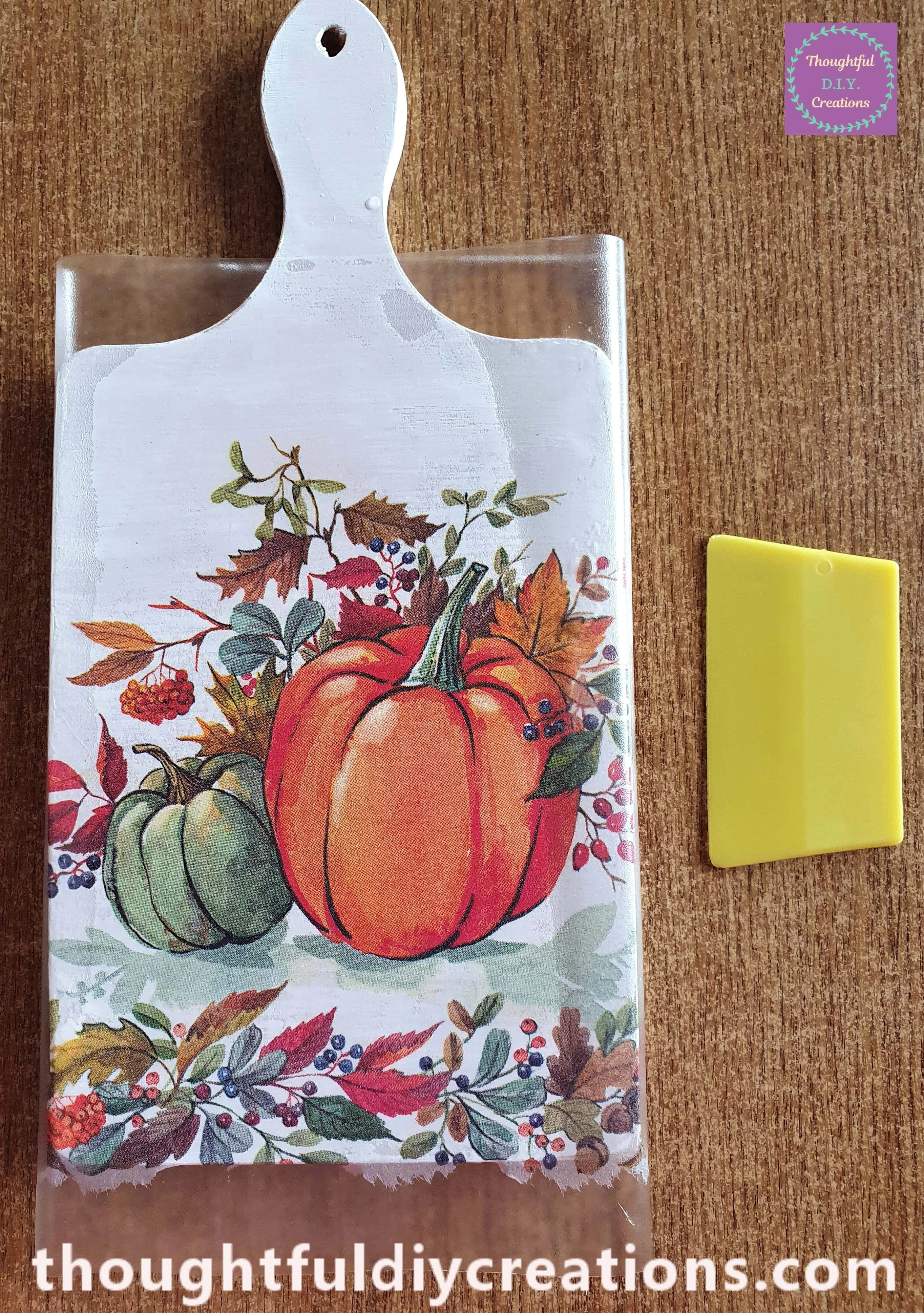 I folded the Plastic Sheet around the Chopping Board and pressed the squeegee tool on the Plastic on the Sides of the Chopping Board to attach the design to the sides of the chopping board.