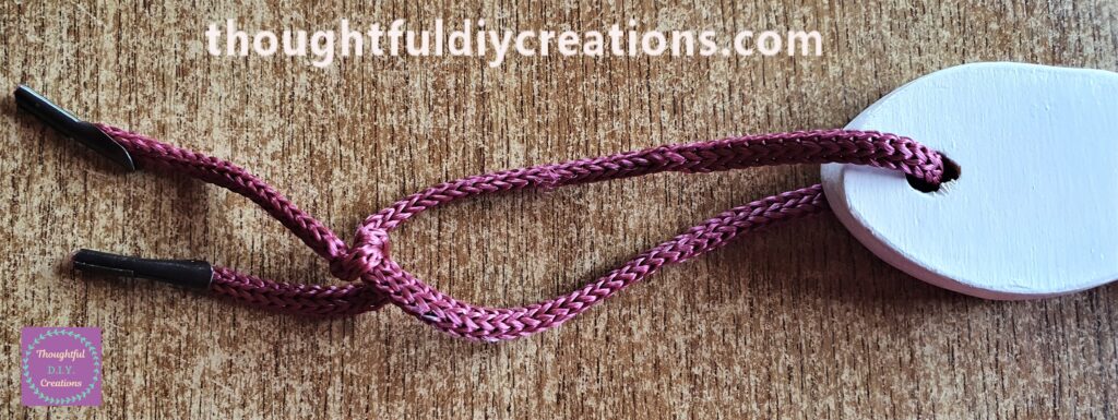 I put it through the hole of the Decoupaged Chopping Board and tied it in a Double Knot.