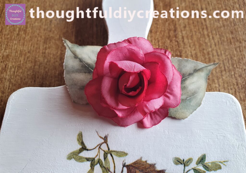 I put Hot Glue behind the Flower and attached it in the center of the leaves.