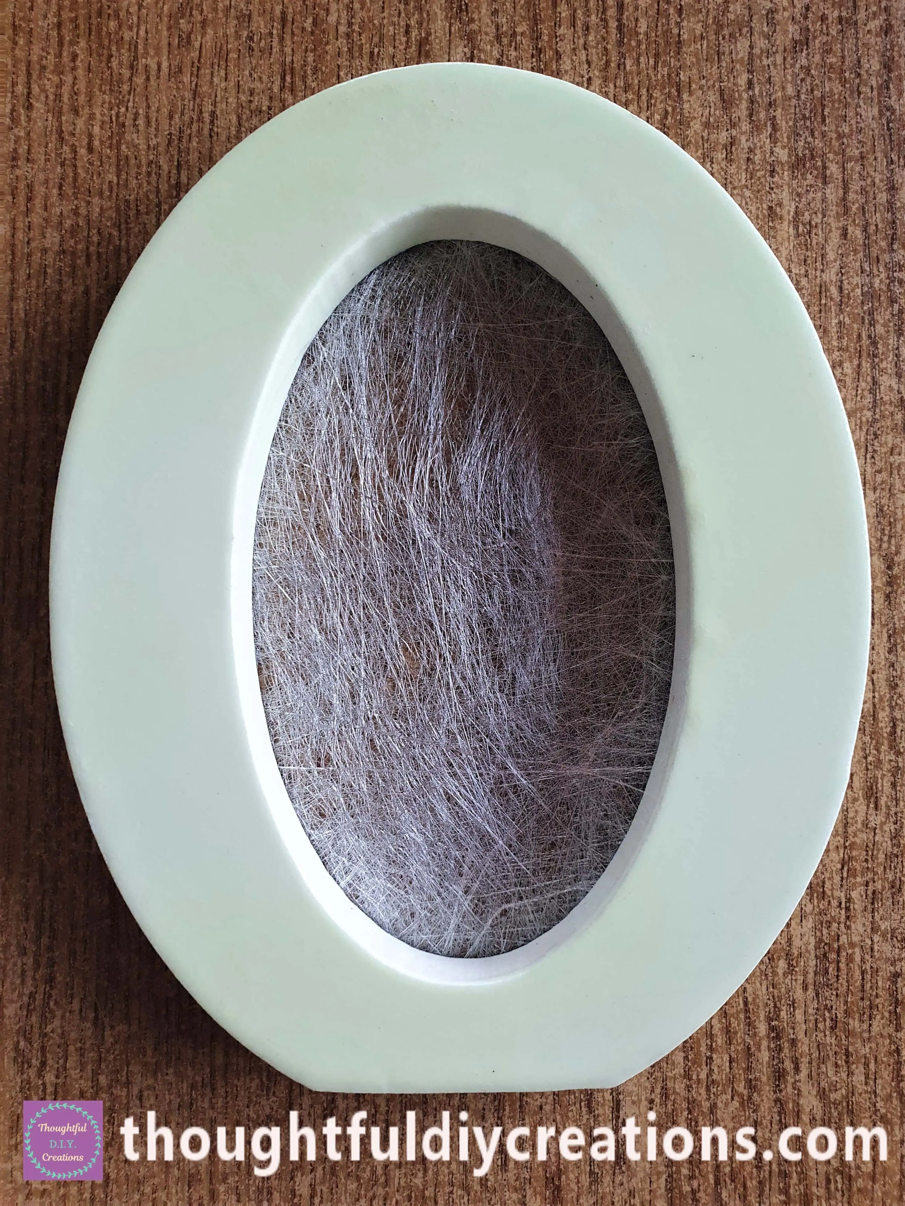 This is the Front of the Letter 'O' with the Silver Paper attached. It looks like a Cobweb.