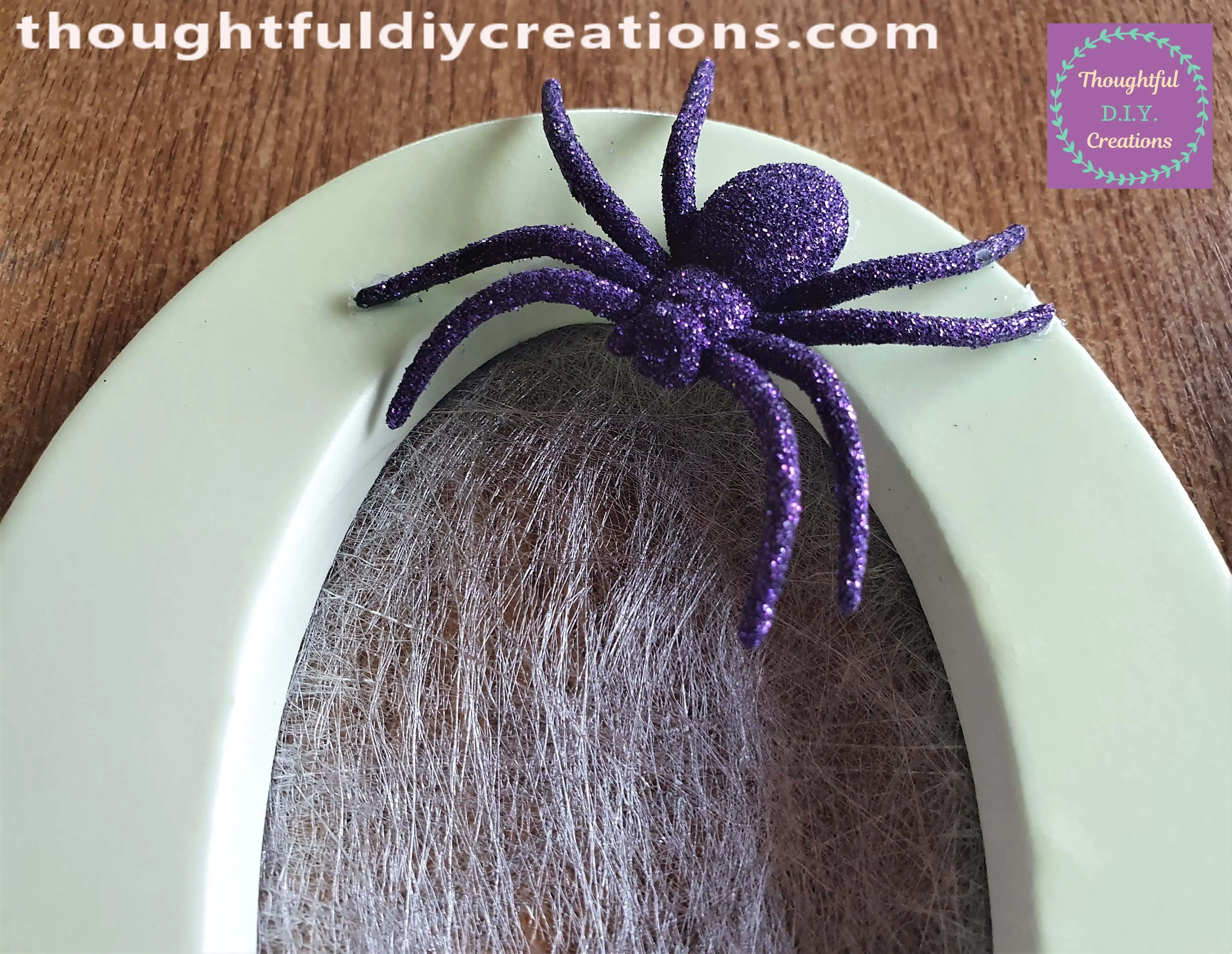 I attached One Spider to the Top of the Letter 'O' with my Hot Glue Gun.