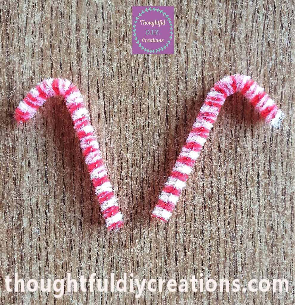 I bent the top of each Pipe Cleaner forward to make the Shape of a Candy Cane.