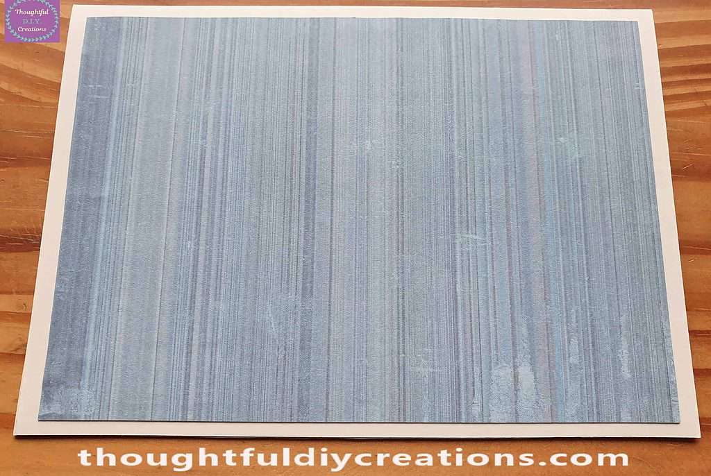 I attached the green paper to the Christmas Card and pressed it into place.